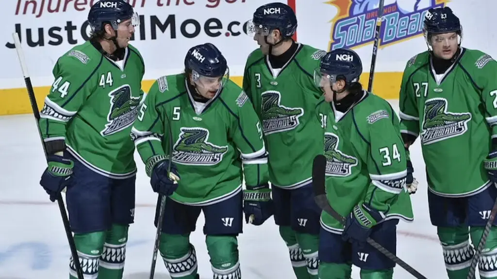 Hockey players in green jerseys on ice